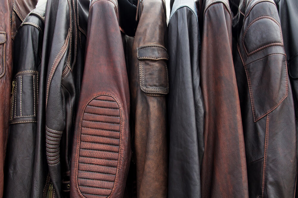 a collection of leather jackets on rack